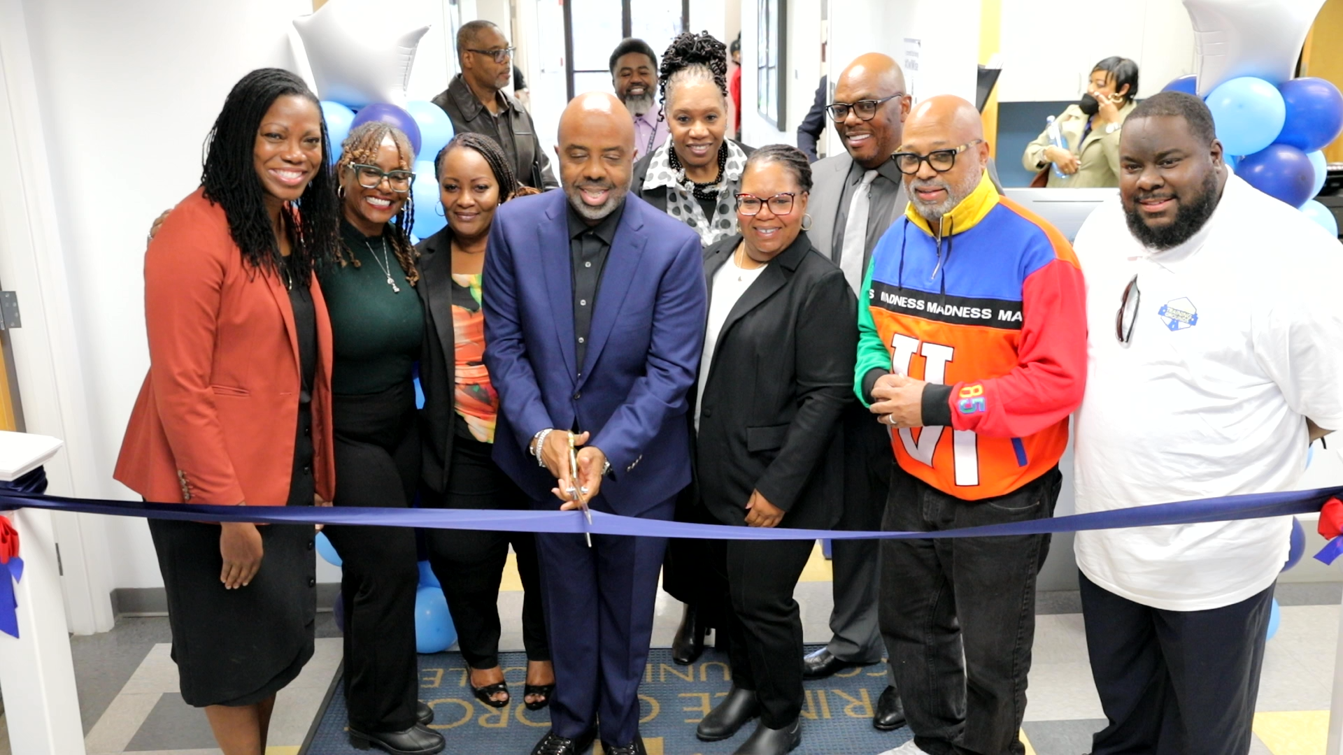 A group of people cutting a ribbon.