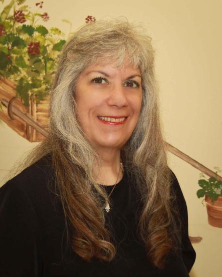 Pamela Marcus smiles wearing a black sweater.