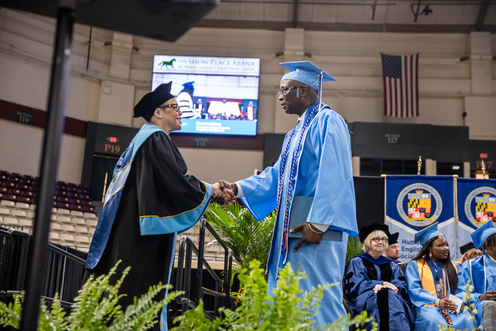 Chair Tomeka Bumbry congratulates Eric Colquitt at PGCC Commencement