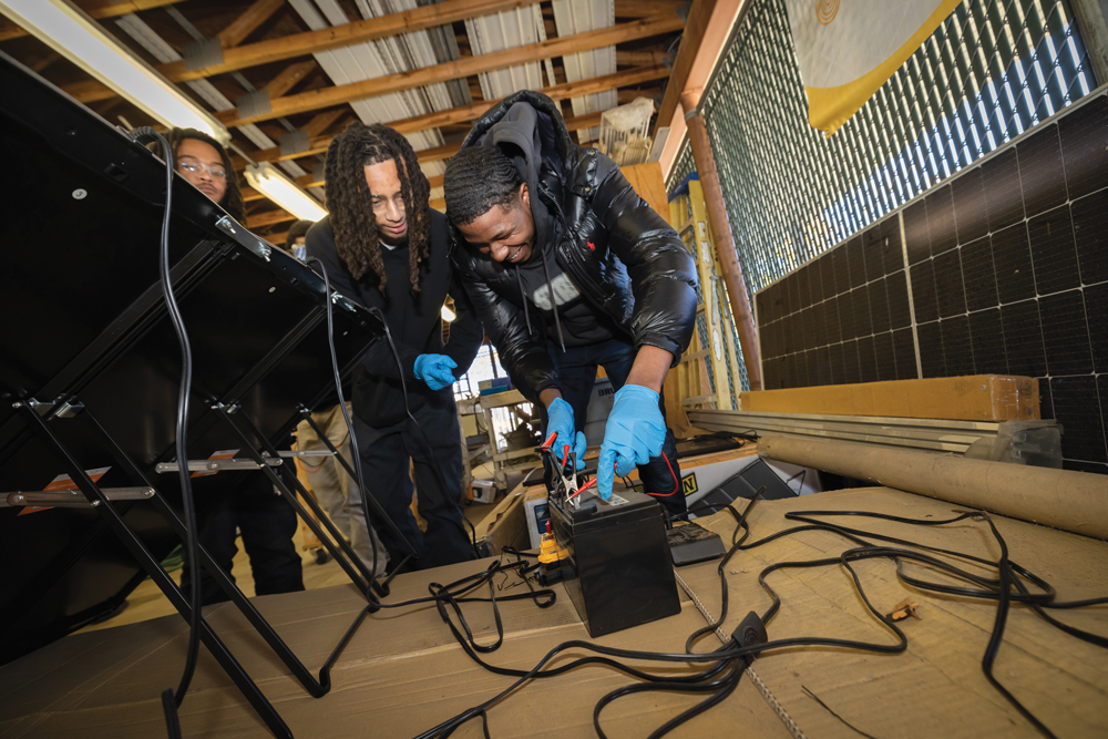 Students working on solar panels at team builders academy.