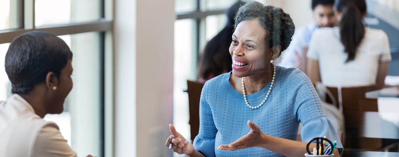 An IRS Volunteer Income Tax Preparer Discussing Tax Preparation Services
