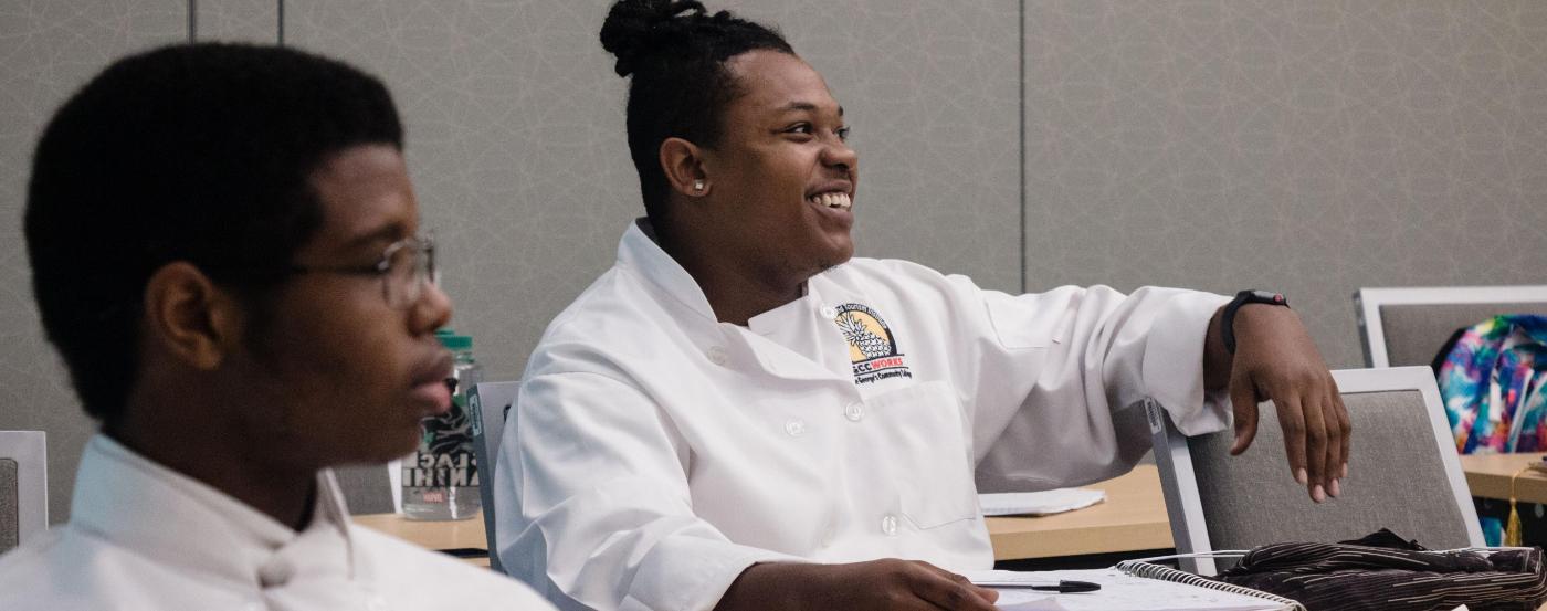 Hospitality and Culinary Arts students listen to a presentation in a classroom