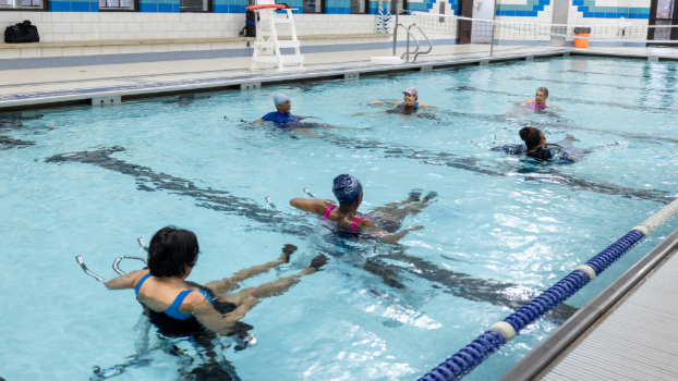 Students are taking aquatic cycling lessons in the pool