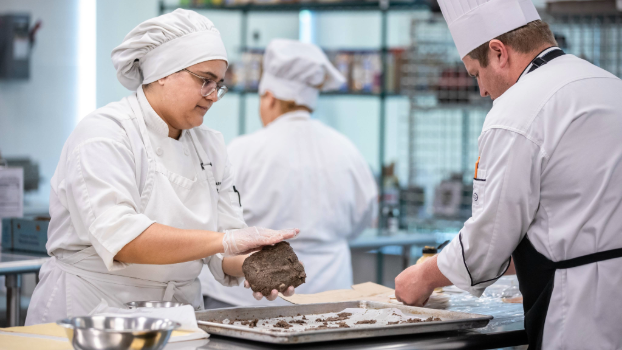 culinary arts students preparing meat