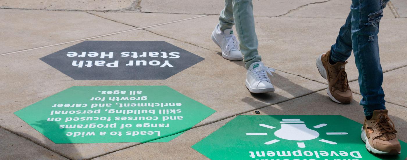 Students Walking on Professional and Personal Development Pathway Hexagons