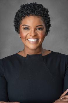 Mariko Bennett smiles at the camera in a portrait.