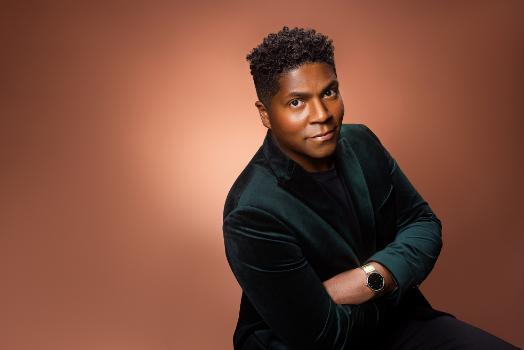 Javier Nero Portrait, wearing black suit on neutral background