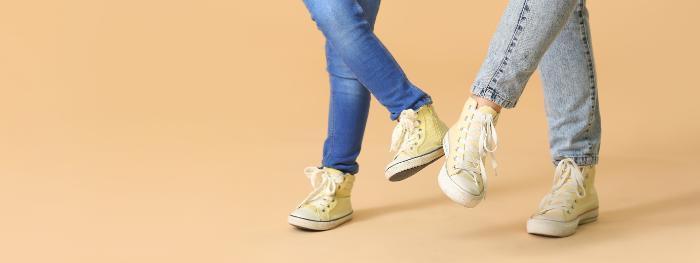 2 pairs of feet dancing in sneakers